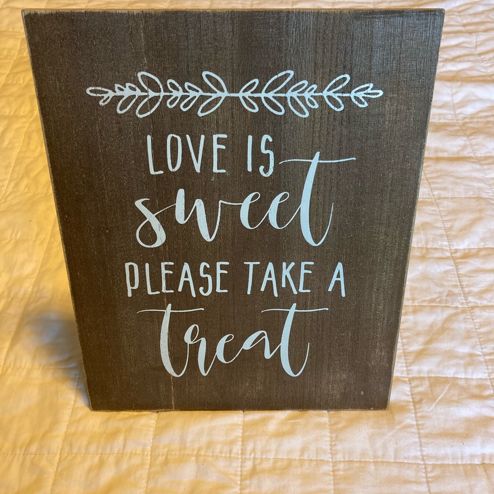 “LOVE IS SWEET PLEASE TAKE A SWEET” sign